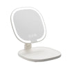A white LED makeup mirror with a round frame and magnification indicators sits on a flat base.