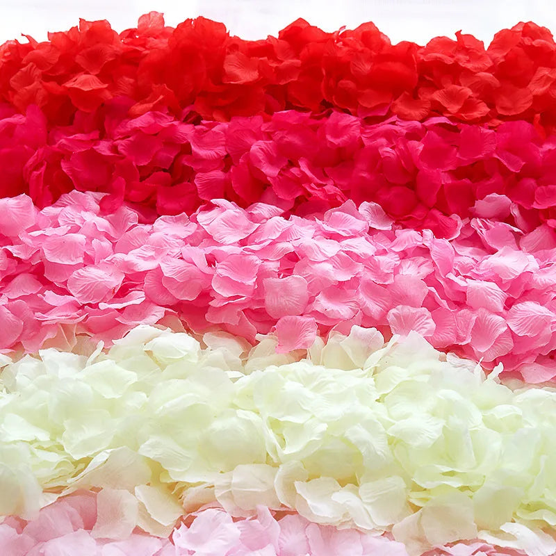 A colorful display of silk rose petals in shades of red, pink, and white.