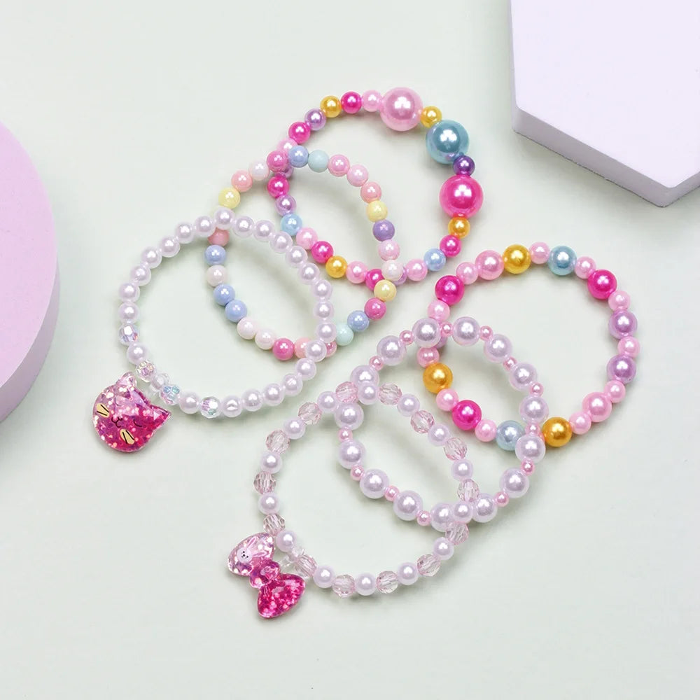 A set of six beaded bracelets featuring pink, purple, and blue stones in various shades and sizes.
