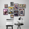 A collection of nine posters featuring characters and scenes from the Soul Eater anime displayed on a white wall.