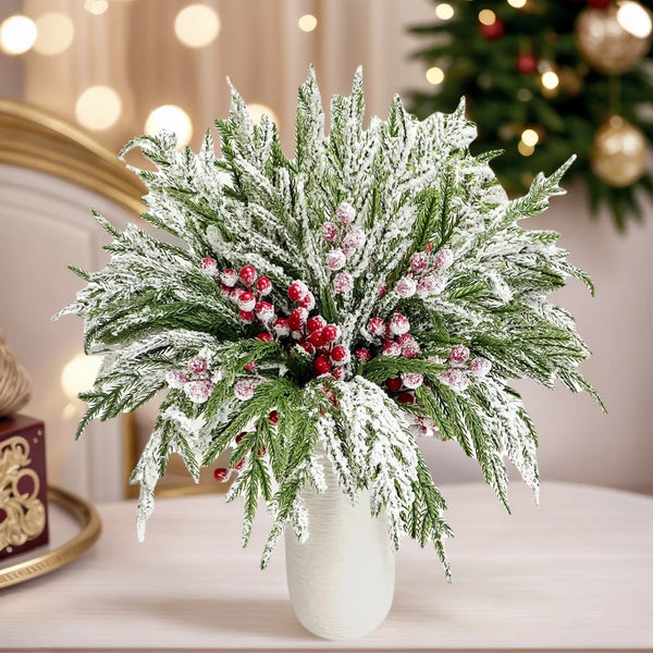 A bouquet of artificial Norfolk pine branches with red berry stems covered in white frost for holiday decor