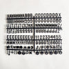 A black wooden message board featuring various symbols, letters, and punctuation marks arranged in a grid.