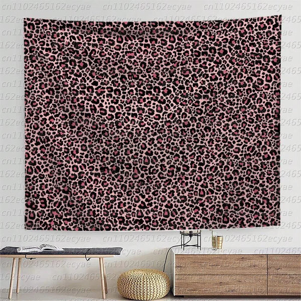 A close-up of a wall tapestry featuring a dense leopard print pattern in shades of pink and black.