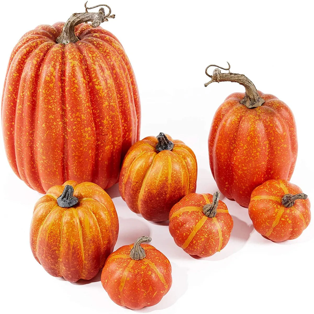 A set of seven orange artificial pumpkins of various sizes displayed on a white background.