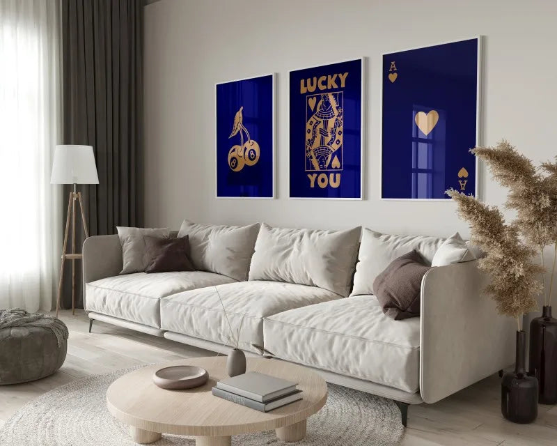 A modern living room features a light sofa and wooden table with a set of retro letter art canvases on the wall.