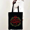 Black tote bag featuring a festive Christmas design with 'Merry Christmas' written in red script surrounded by green foliage.