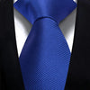A dark blue silk necktie with a diagonal stripe pattern worn against a black suit jacket.