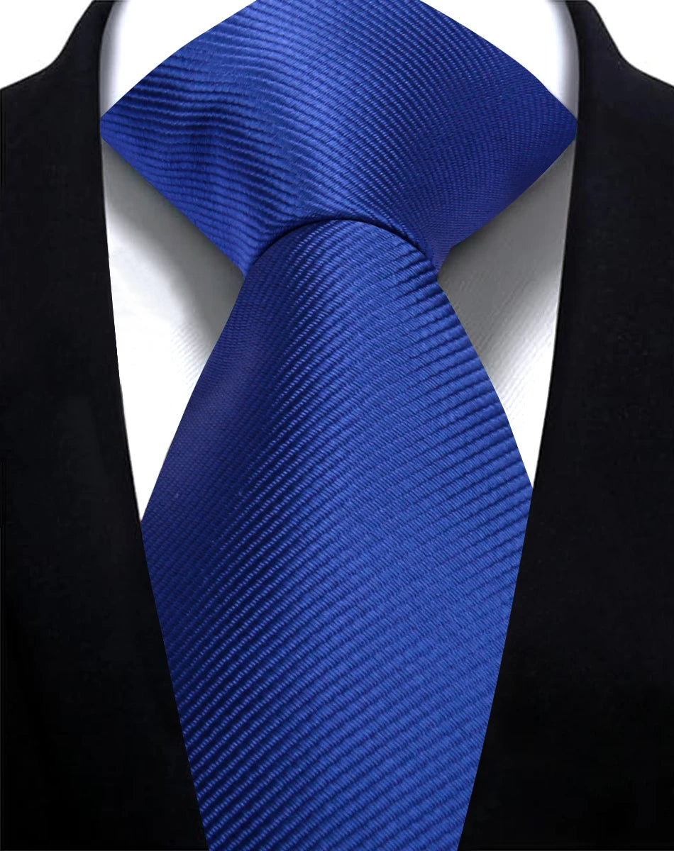 A dark blue silk necktie with a diagonal stripe pattern worn against a black suit jacket.
