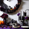A set of four gothic vampire tears taper candles with a dripping blood effect displayed on a purple surface.