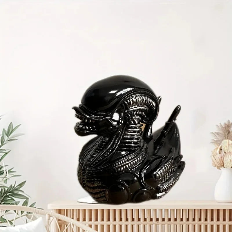 Black resin statue of an alien duck with intricate textures on a wooden surface.