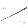 A long, dark brown metal magic wand with an intricately carved handle and a small inset detail.
