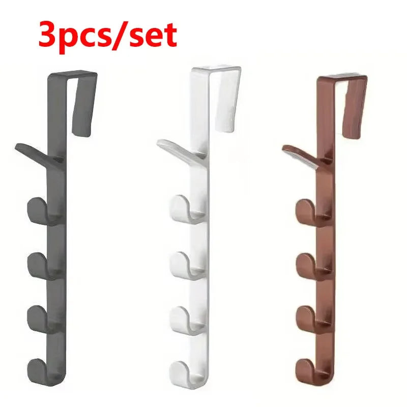 A set of three black and copper over-the-door hooks for bags, hats, and scarves.