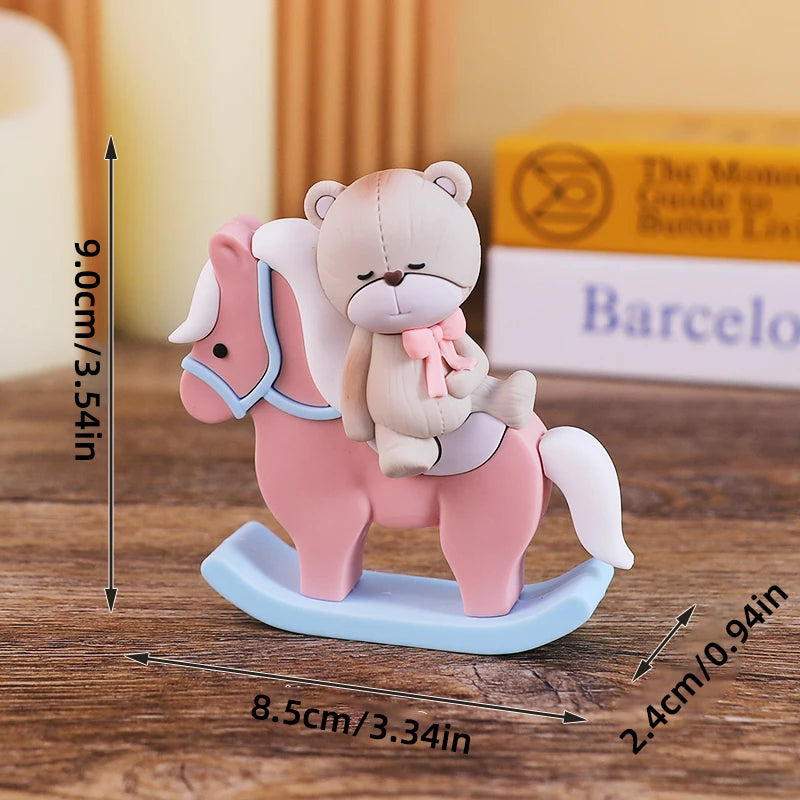 A pink baby block featuring a teddy bear and a horse design, displayed on a wooden surface.