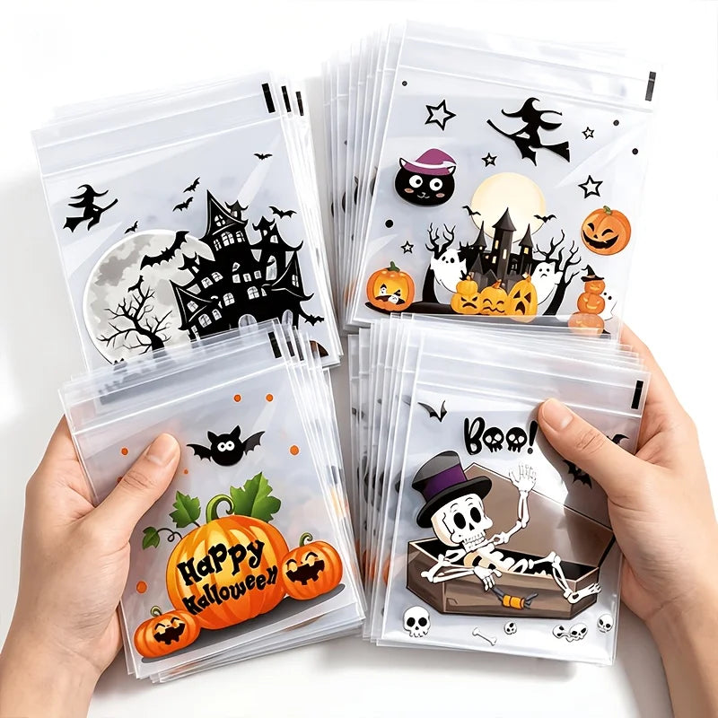 A hand holds a stack of clear self-adhesive treat bags decorated with Halloween themes like bats pumpkins and spooky silhouet