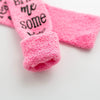 Pink plush slipper socks with a black quote design featuring the words me some wall