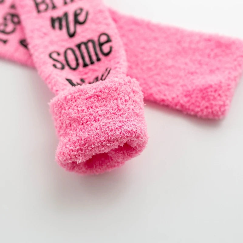 Pink plush slipper socks with a black quote design featuring the words me some wall