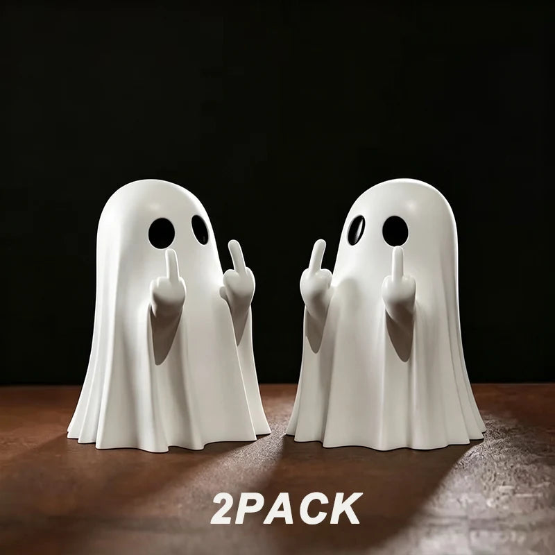 A pair of white glow-in-the-dark ghost figurines with playful poses displayed on a dark surface.