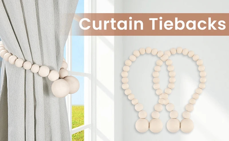 A set of natural wooden bead curtain tiebacks used to hold a light gray curtain.