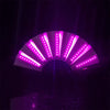 A folding hand fan illuminated by bright purple LED lights, creating a radial pattern against a dark background.