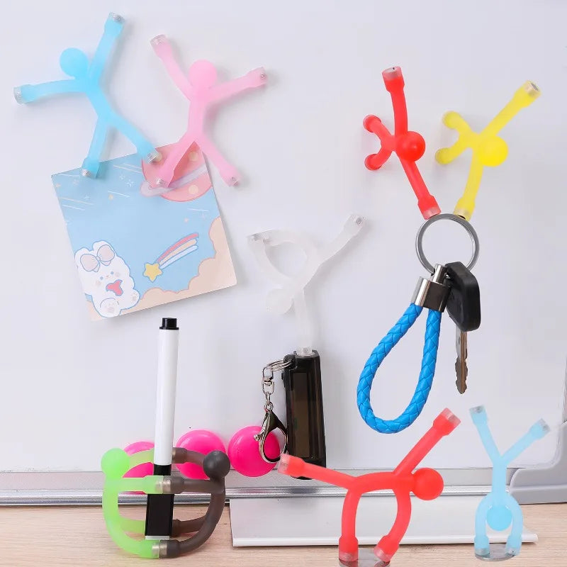 A collection of colorful flexible mini figures and magnets displayed against a white background.