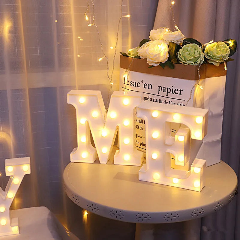 Warm white LED alphabet letter lights spelling out 'ME' displayed on a wooden sign.