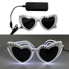 Pair of white heart-shaped sunglasses with 'just married' text and LED lights on a black strap