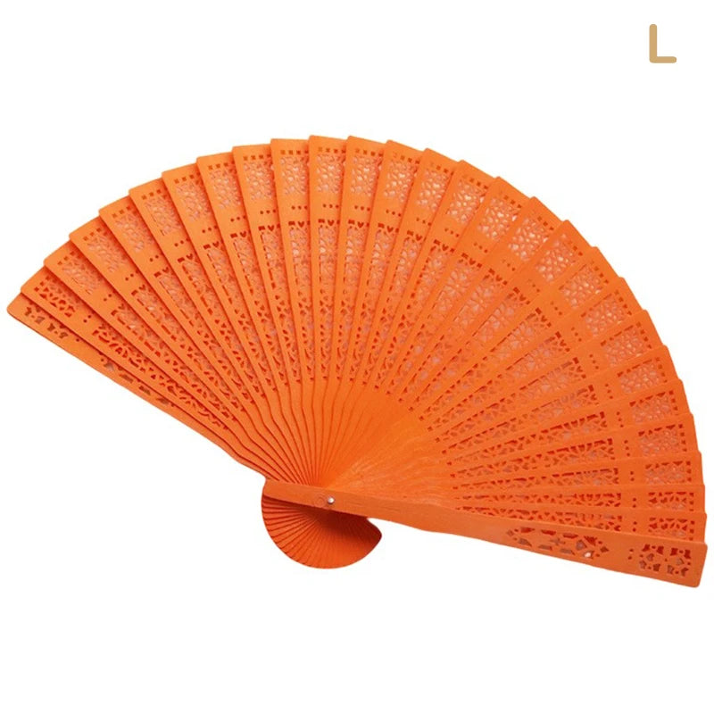 Hand carved bamboo folding fan in bright orange color shown open and angled.
