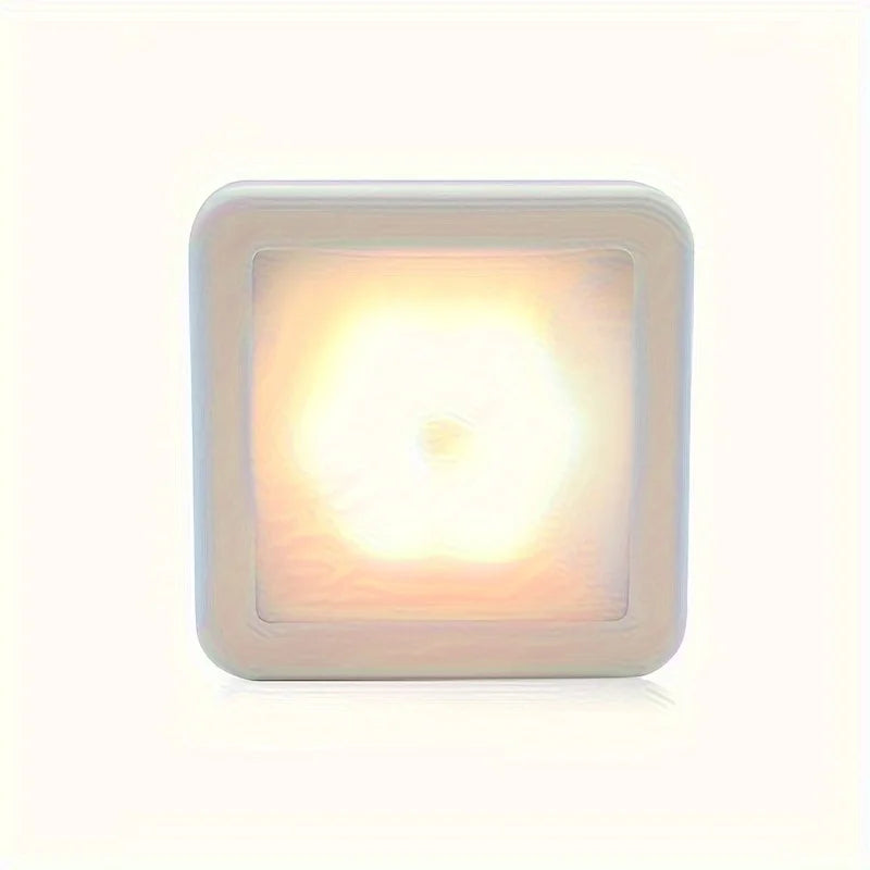 A square LED night light with a translucent yellow glow housed in a white frame.