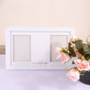 A white wooden frame with two recessed squares and the text Love at first sight, decorated with pink roses.