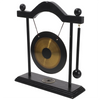 A black and brass gong decor set featuring a large circular gong suspended by a stand.