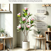 An instant corner upgrade featuring an artificial magnolia tree with pink silk flowers in a white pot.