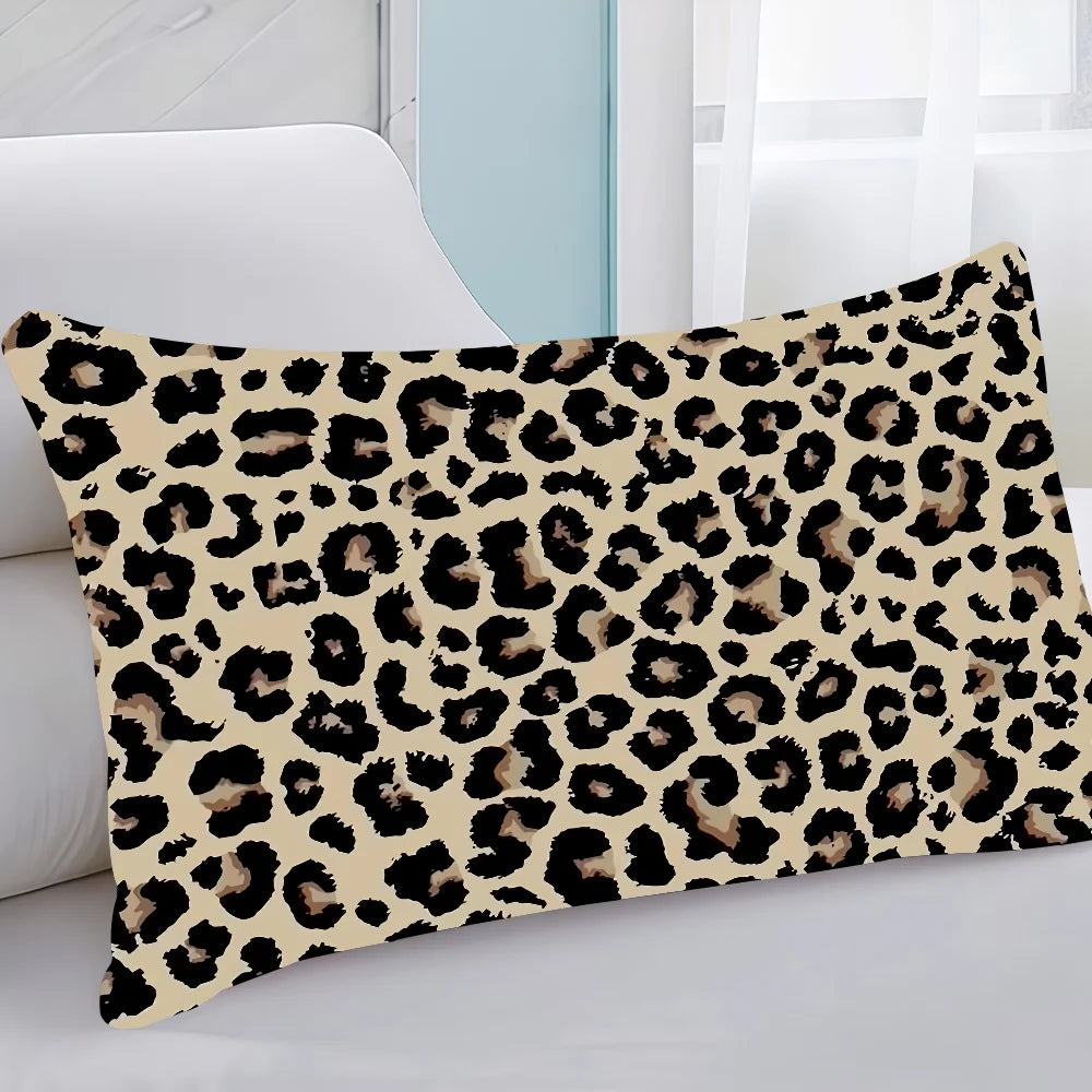 A decorative pillow cover featuring a black and brown leopard print on a cream background.