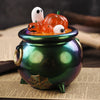 A green ceramic pot holds a Halloween silicone mold set featuring orange pumpkins and white ghosts.