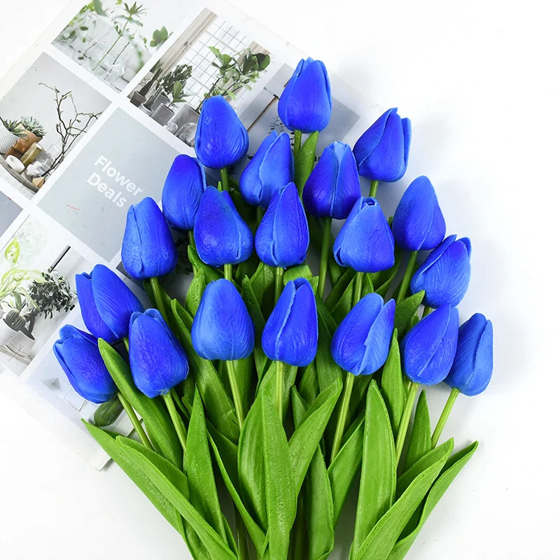 A bouquet of vibrant blue artificial tulips with green stems and leaves.