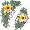 A floral kit featuring yellow and white flowers and dusty rose eucalyptus greenery for a wedding arch decoration.