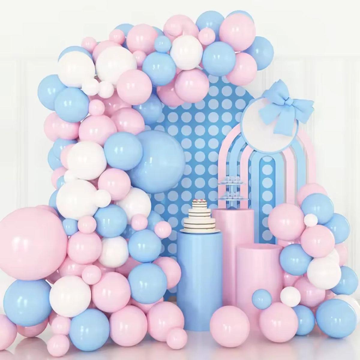 A large arrangement of pastel pink and blue latex balloons forming a decorative backdrop.