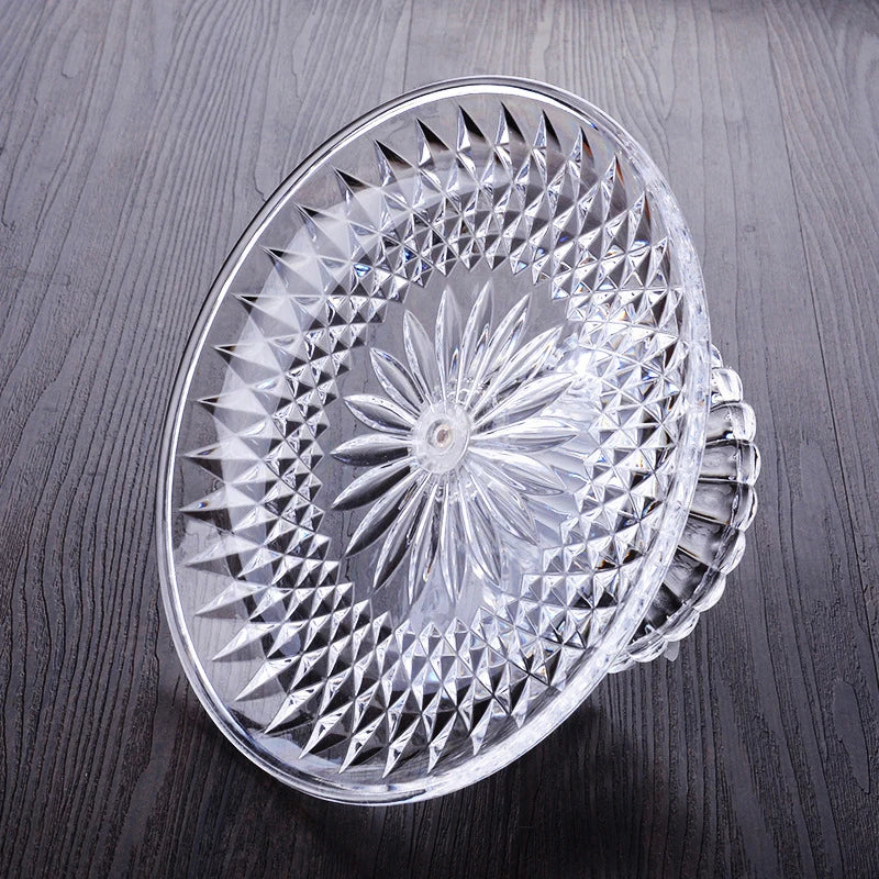 Clear acrylic serving plate with a decorative, sunburst pattern for desserts or salads.