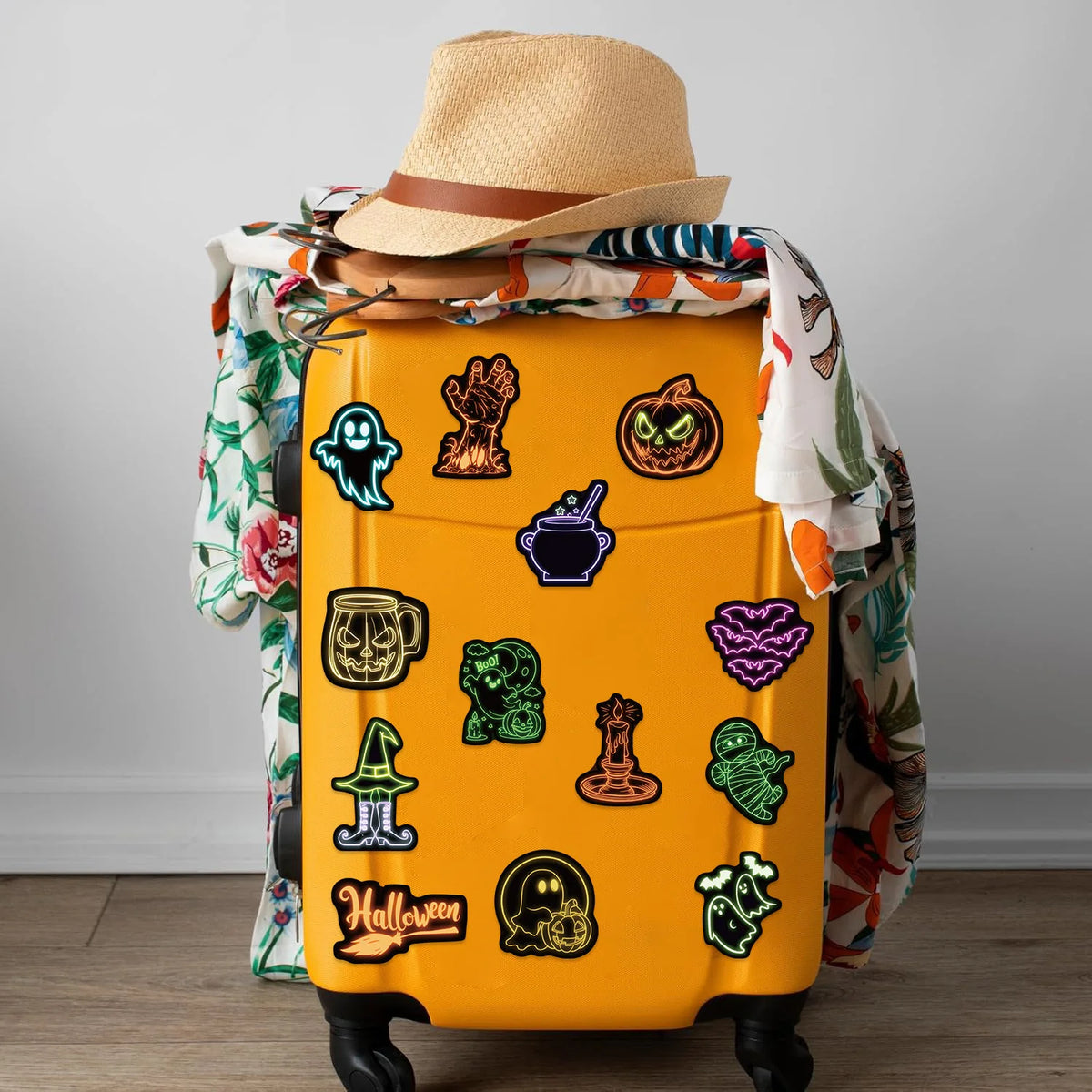 A yellow storage box decorated with Halloween-themed graffiti design stickers and topped with a straw hat.