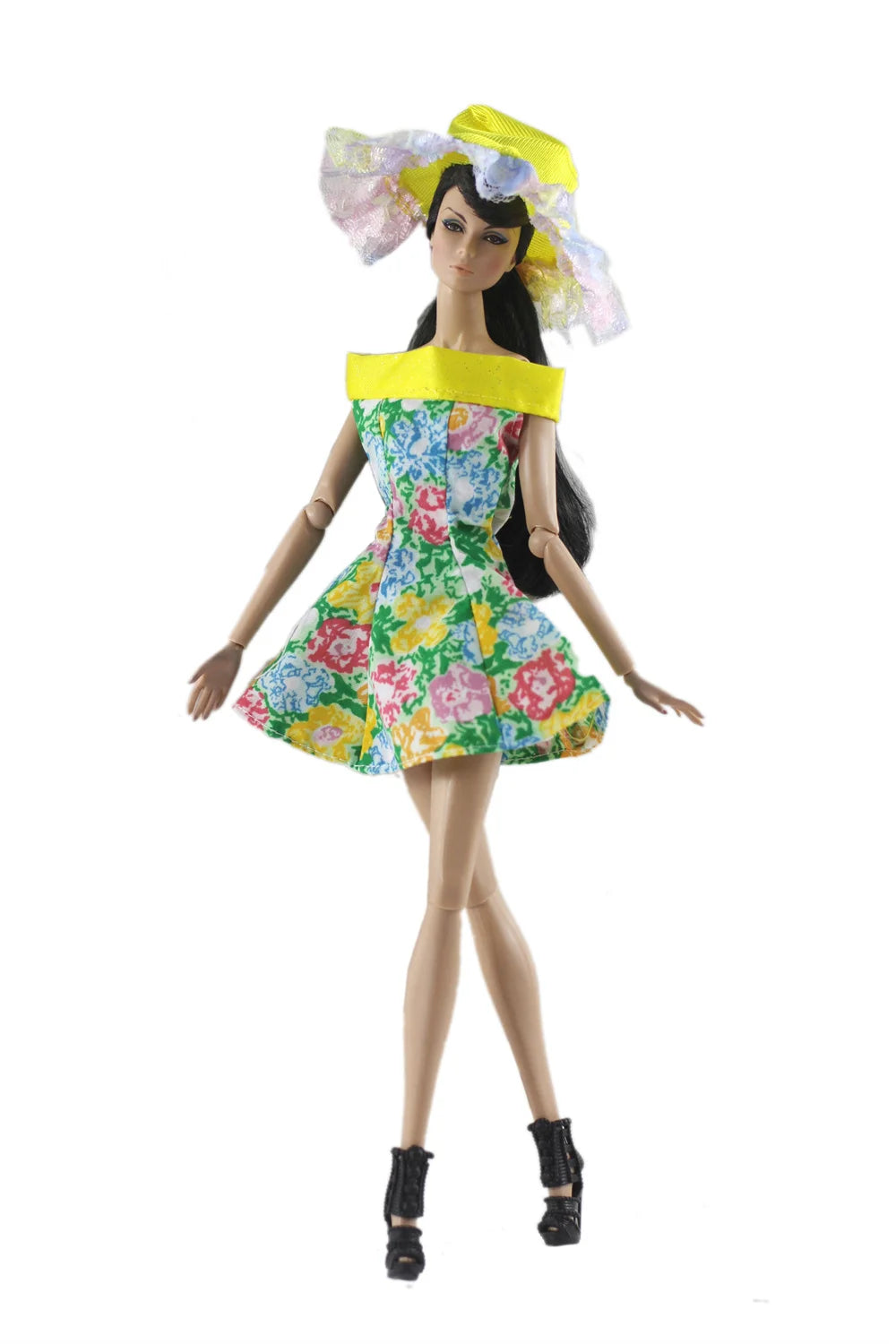 A handmade doll dress gown featuring a floral print and a yellow collar, worn by a fashion doll.