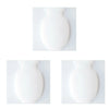 A white, smooth, rounded wall flower vase shown in two views.