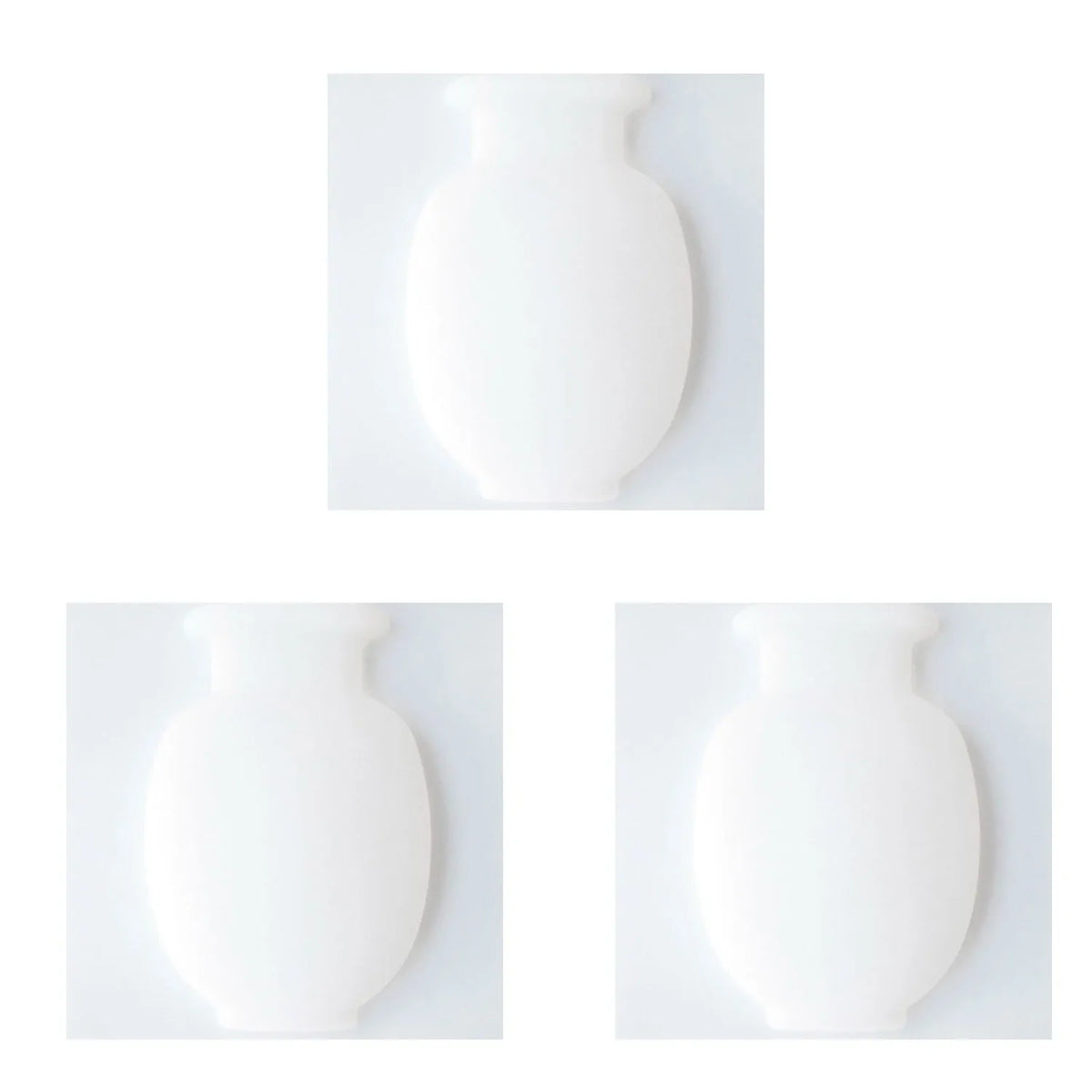 A white, smooth, rounded wall flower vase shown in two views.
