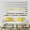 Acrylic mirror strip wall stickers installed horizontally on a white wall above a modern sofa and patterned rug.