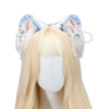 Light blonde wig wearing a blue and white furry fox ears headband for cosplay