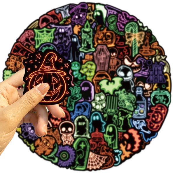 A hand is placing an orange-themed graffiti design photo sticker onto a circular background of various spooky and Halloween-t