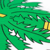 Close-up of a green and white patterned fabric featuring a stylized palm leaf design.