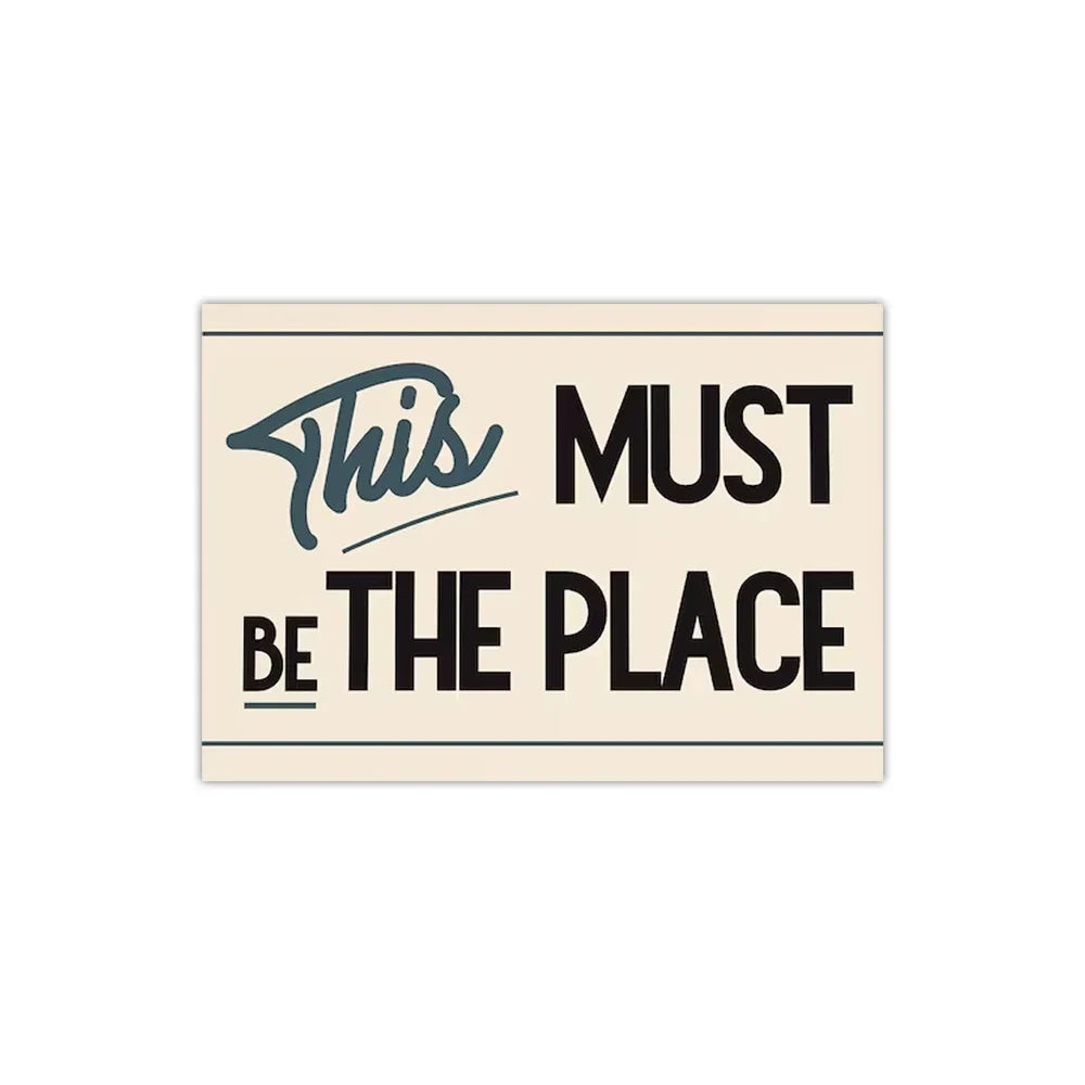 Minimalist text design featuring the phrase This Must Be The Place in black and teal on a beige background.