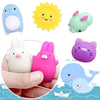 A collection of mini cartoon animal stress relief toys including a blue penguin, yellow sun, green frog, white rabbit, and pu