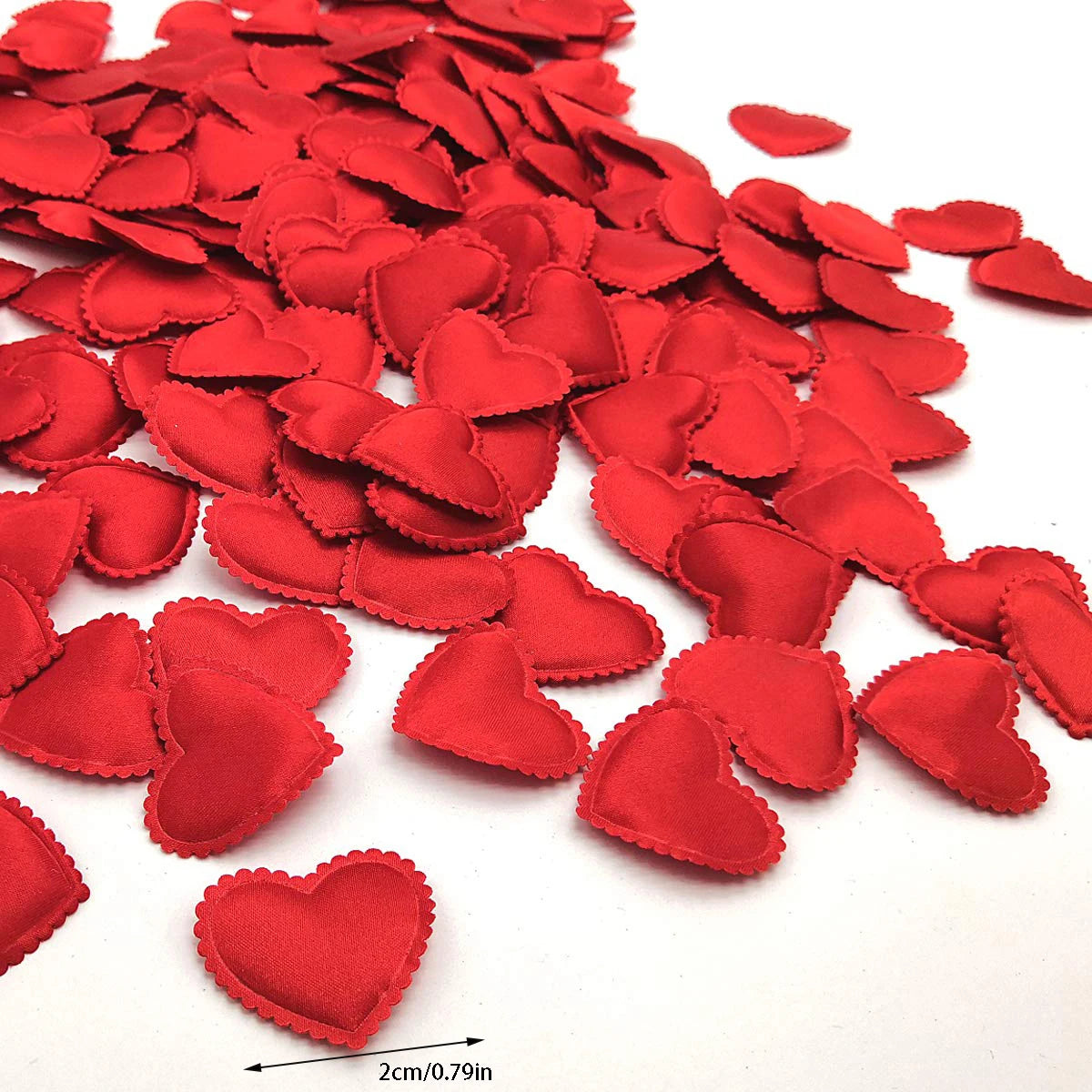A pile of 200 red fabric heart throwing petals for weddings and parties.