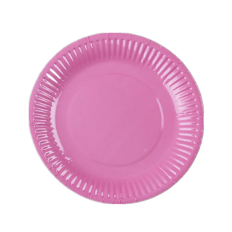 A pink disposable plate with ruffled edges.