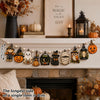 Vintage Halloween wooden hanging garland featuring pumpkin, ghost, and cat beads displayed on a mantelpiece.